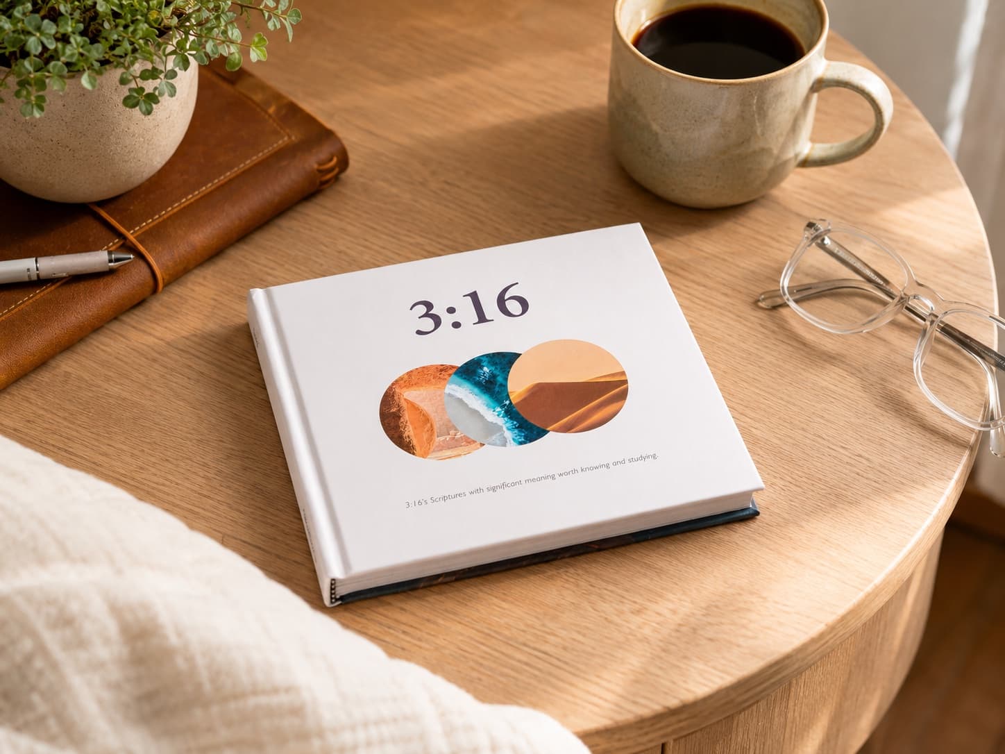 The 3:16 book on a sunlit table beside a journal and coffee